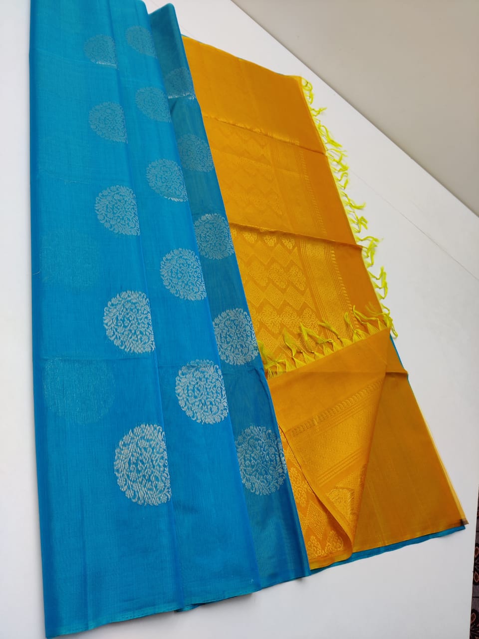 Cotton silk pure borderless in blue color with golden butti and Golden yellow mundi